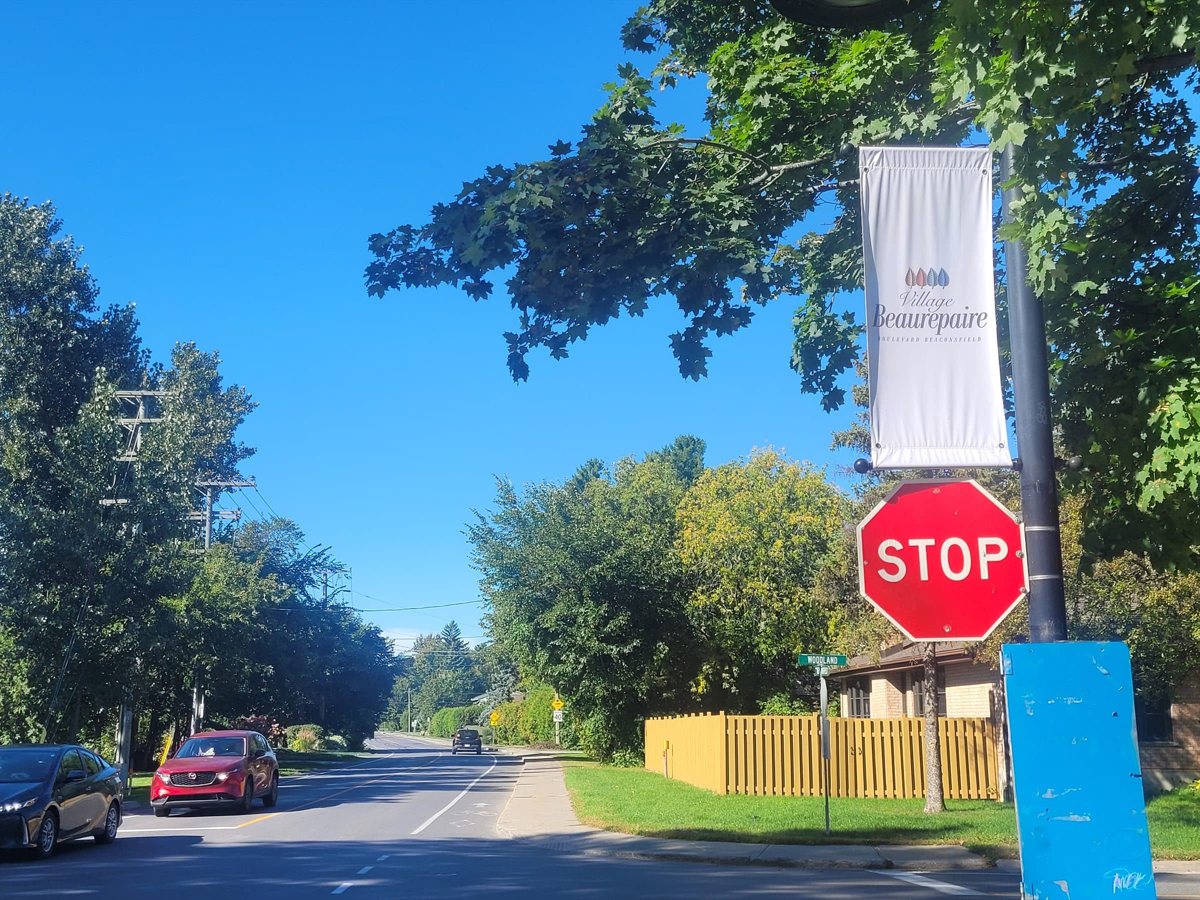 Beaurepaire Village banner on a tree-lined Beaconsfield street