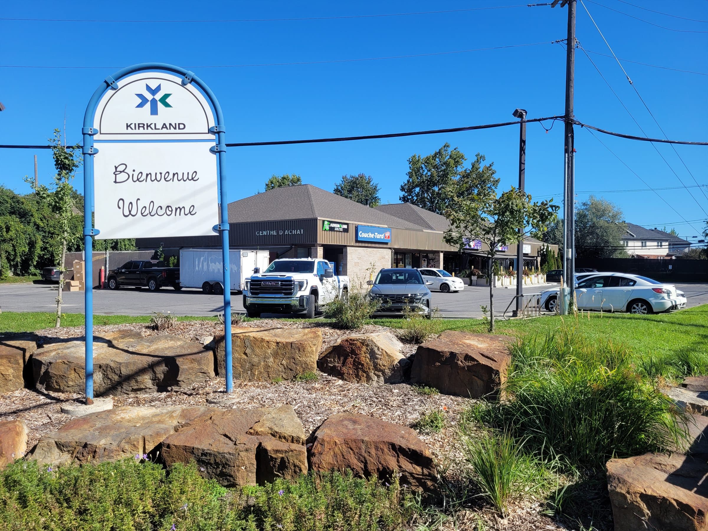 Kirkland welcome sign beside a landscaped neighbourhood entrance