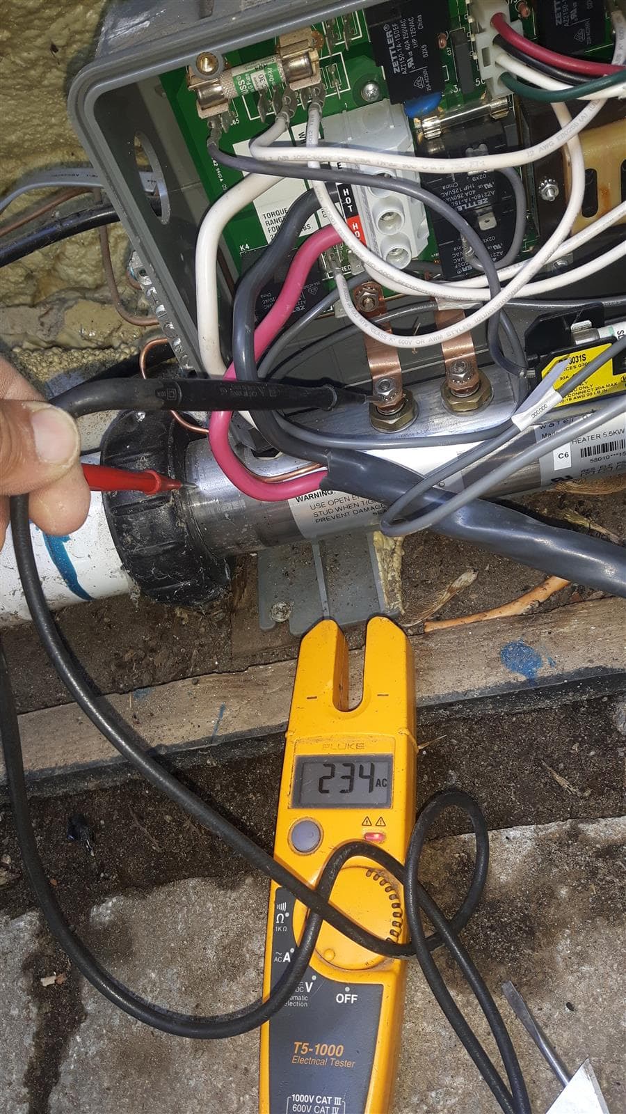 Electrician testing pool equipment wiring