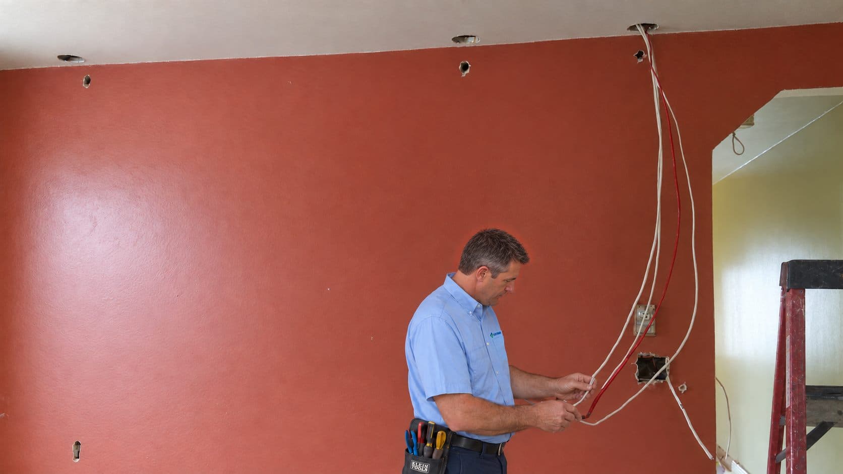 Electrician examining existing wiring in an established home